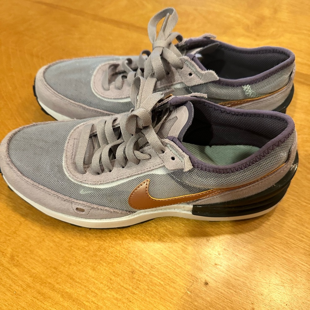 Nike running shoes. Purple and copper.